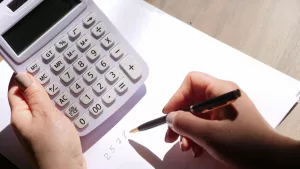 Image of a person working out sums with a calculator